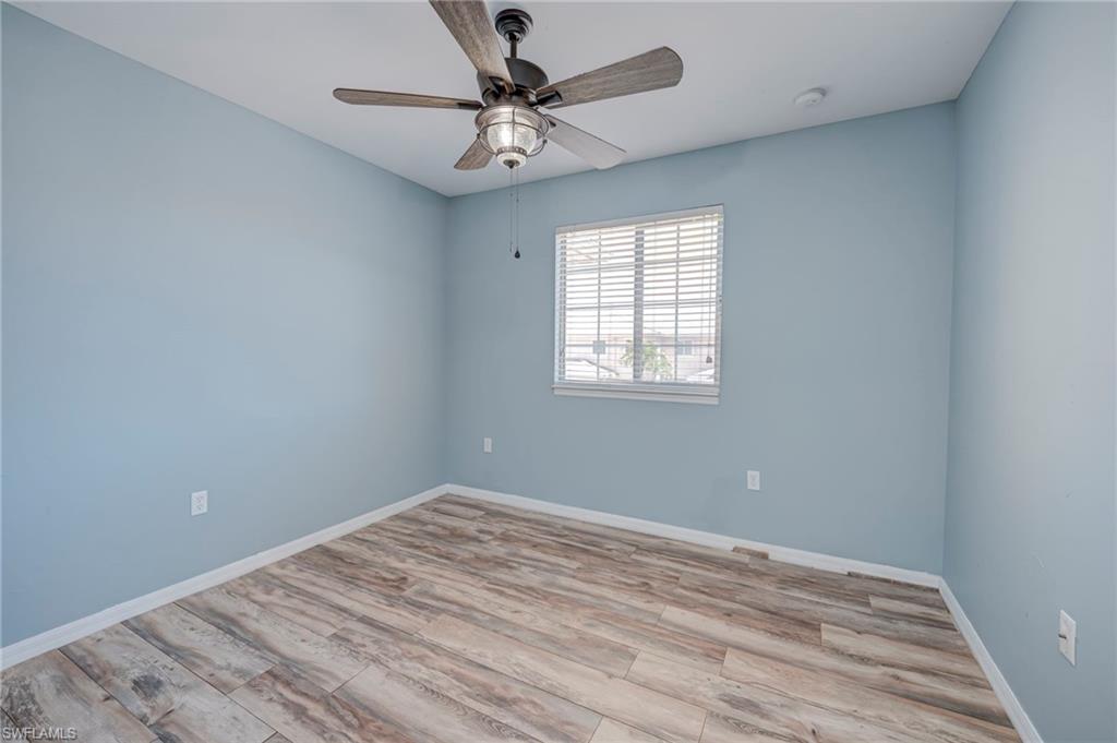 Empty room with light wood finished floors and ceiling fan