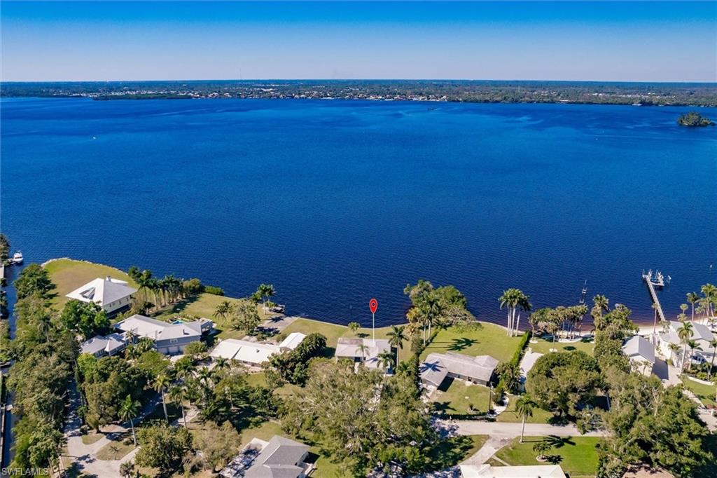 Birds eye view of property with a water view
