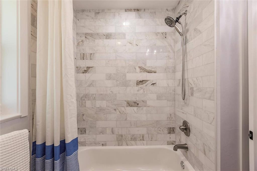 Bathroom featuring shower / bath combination with curtain