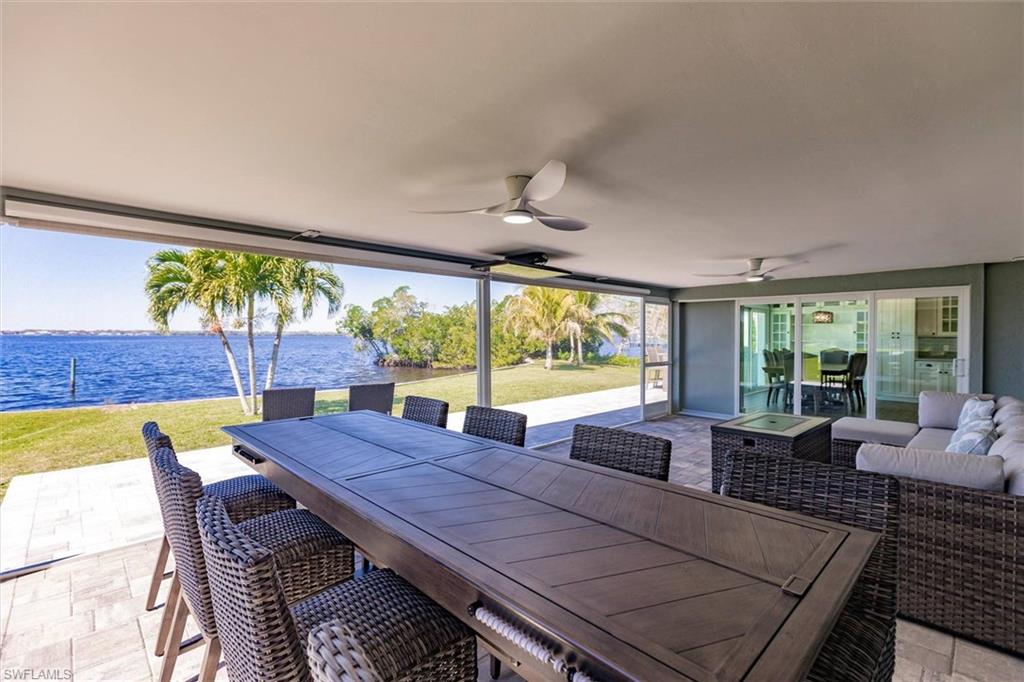 View of patio / terrace with a ceiling fan, outdoor dining space, a water view, and an outdoor living space