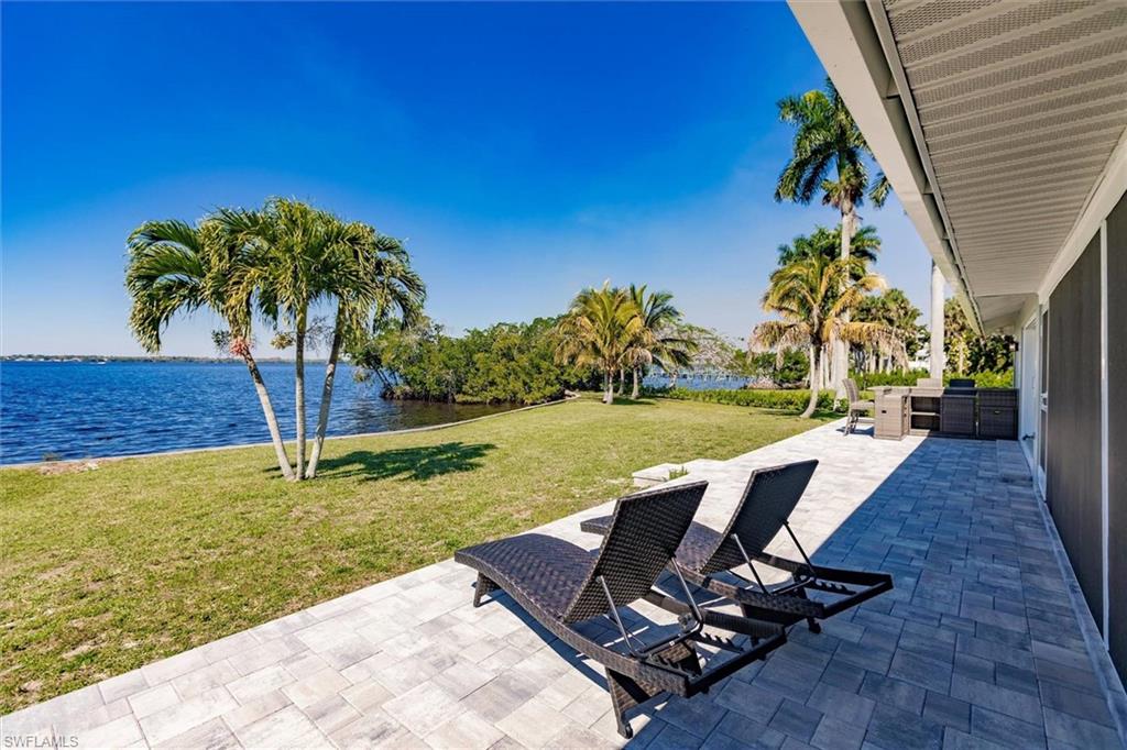 View of patio / terrace with an outdoor kitchen and a water view
