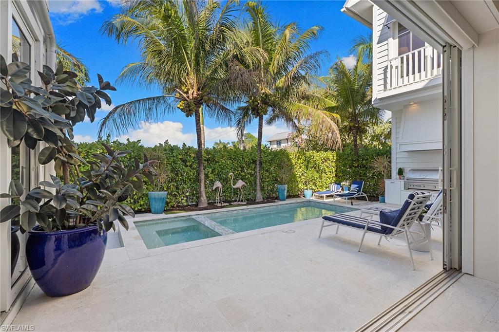 Relaxing pool / spa featuring a patio and a balcony