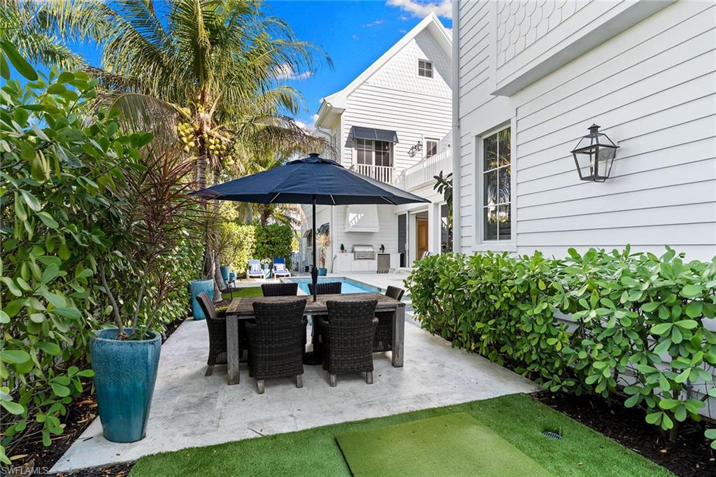 View of patio / terrace featuring outdoor dining area and an outdoor pool