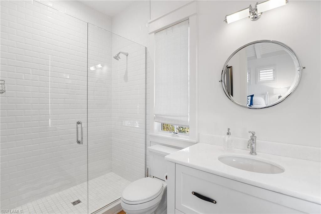 Full bathroom featuring vanity and a stall shower