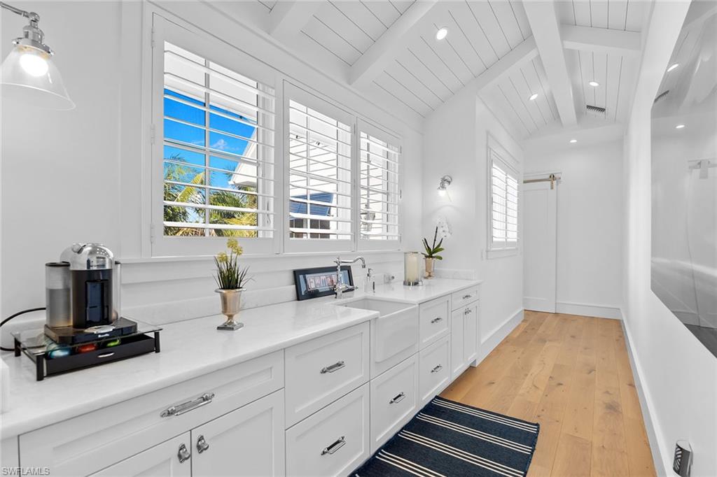 Bathroom with light wood-style floors, vanity, recessed lighting, and a wooden ceiling with exposed beams