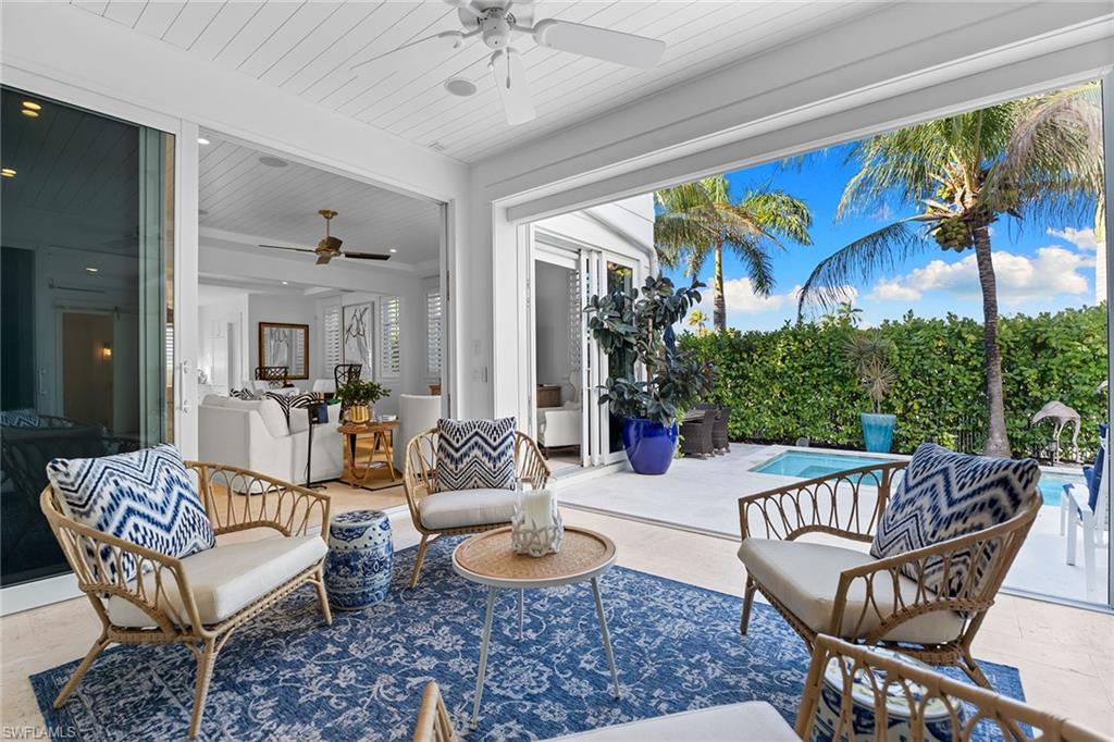 View of patio with ceiling fan and an outdoor hangout area