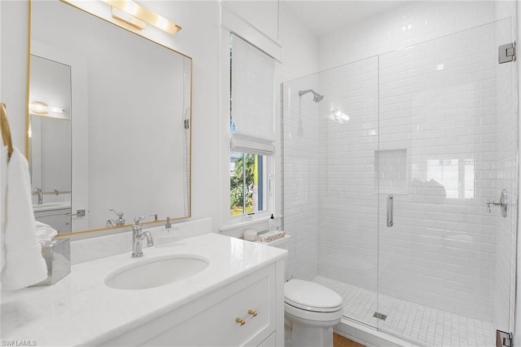 Full bath featuring vanity and a shower stall