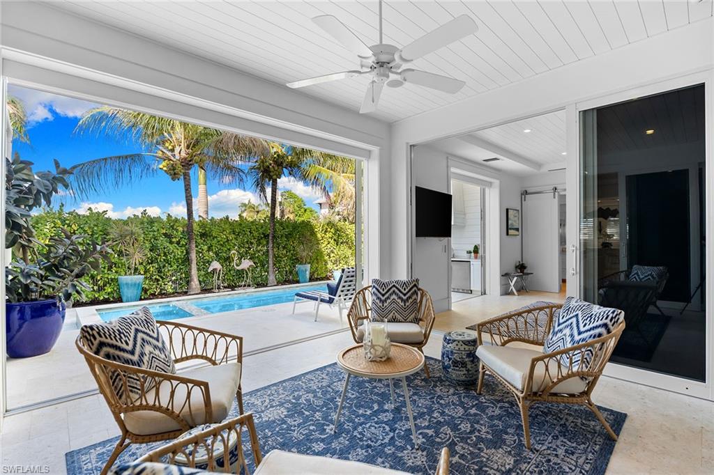 View of patio with a ceiling fan, an outdoor pool, and outdoor lounge area