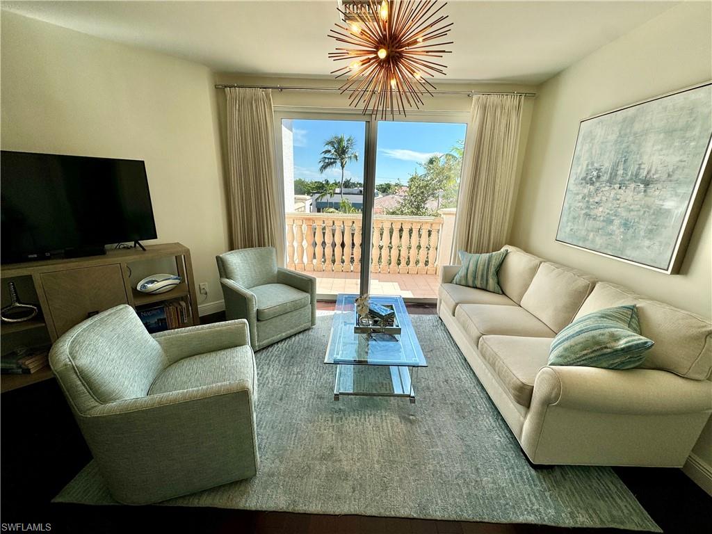Living room with hardwood / wood-style flooring and a chandelier