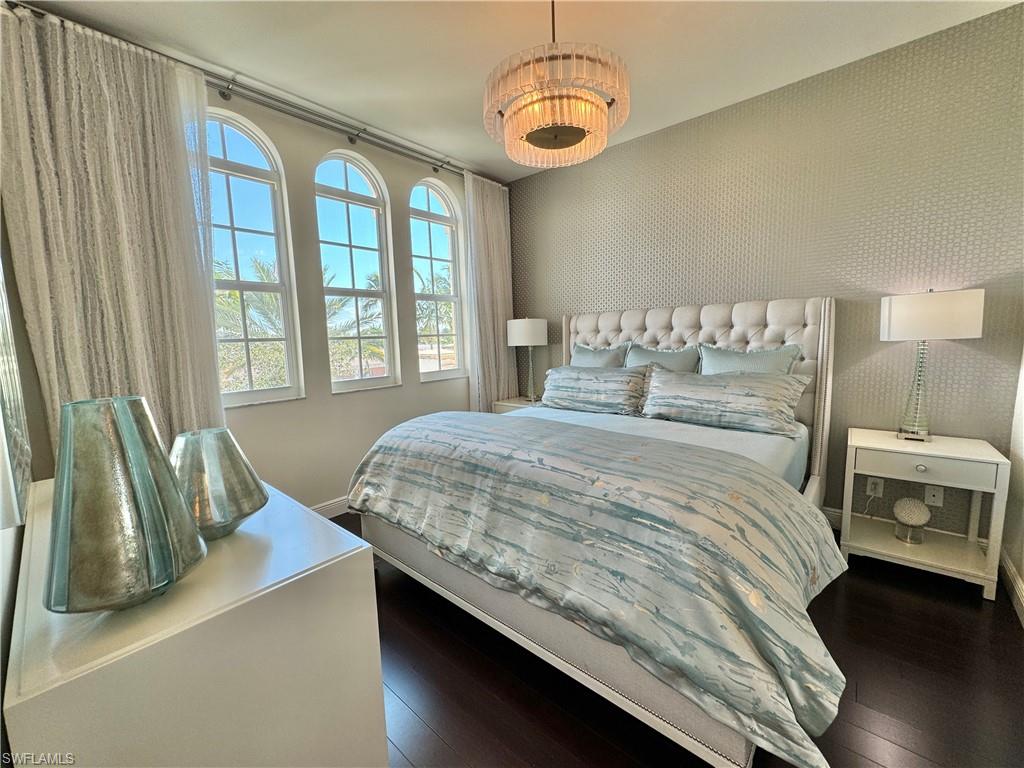 Bedroom with dark hardwood / wood-style floors