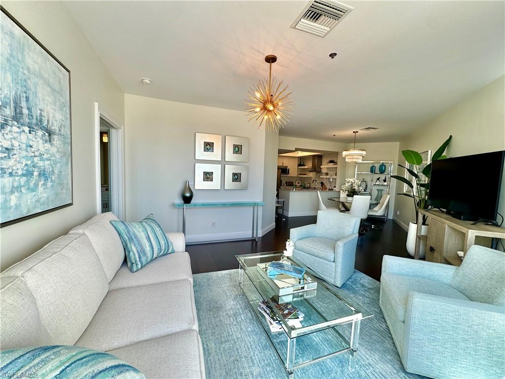 Living room featuring hardwood / wood-style floors and a chandelier