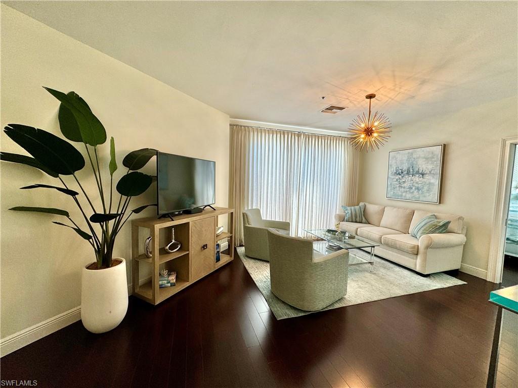 Living room with hardwood / wood-style flooring