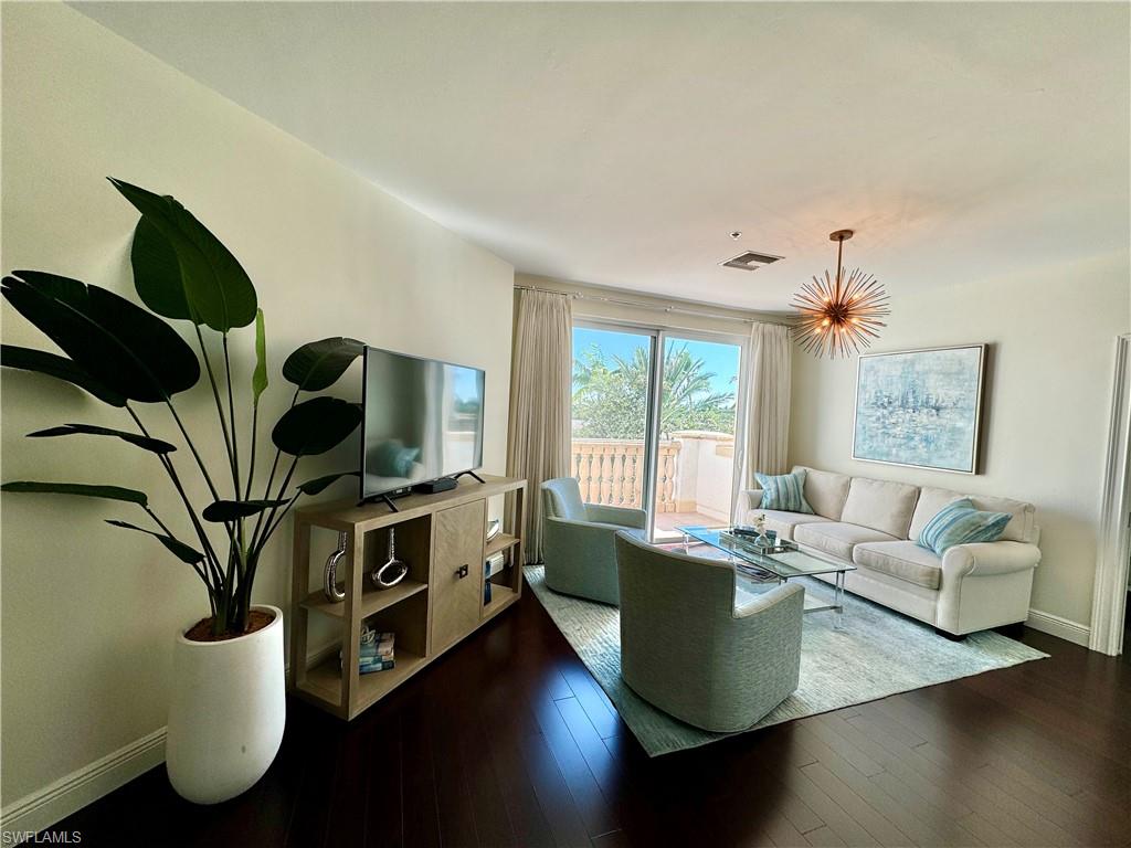 Living room with dark hardwood / wood-style flooring