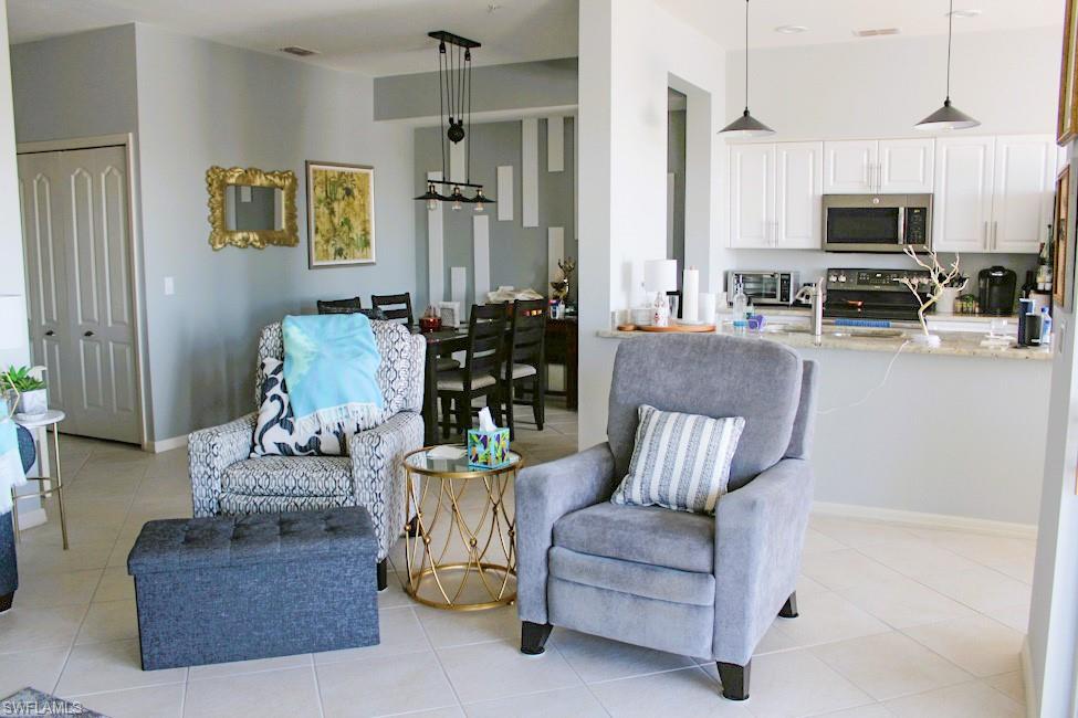 Living area with light tile patterned floors and baseboards