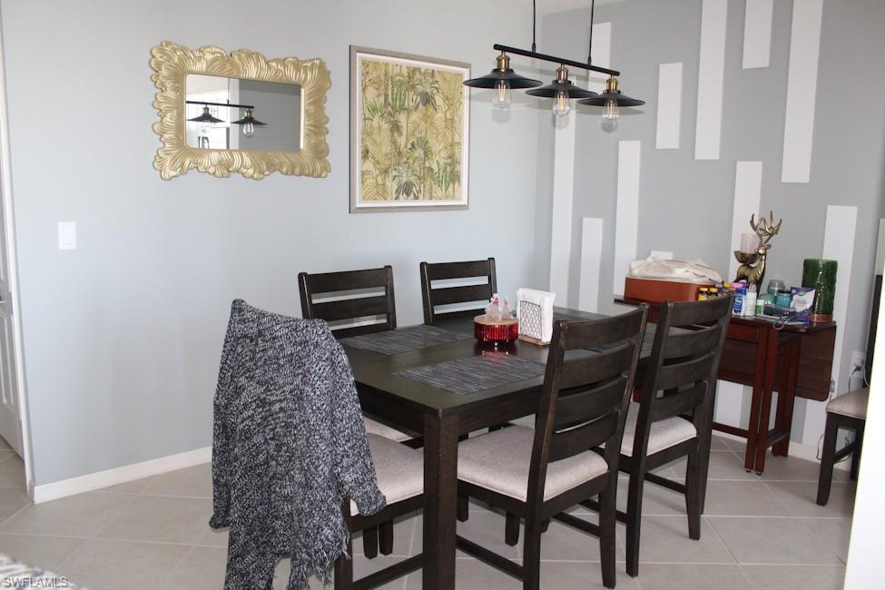 Dining area featuring light tile patterned floors