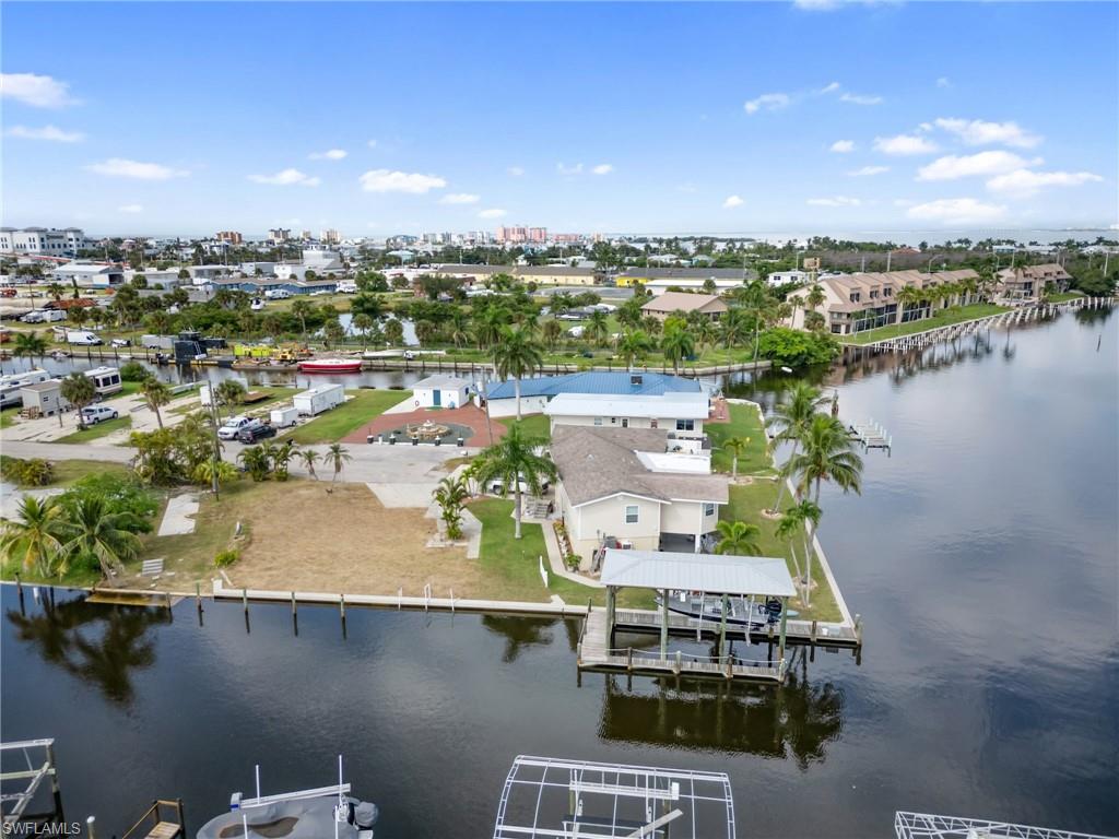 Aerial view of residential area featuring a nearby body of water