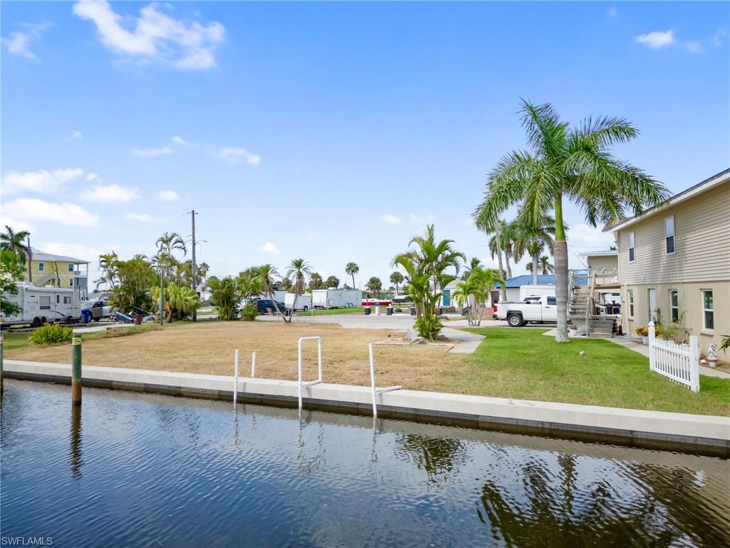 Dock area featuring a lawn, a residential view, and a water view