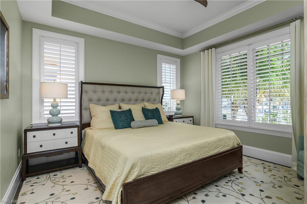 Bedroom featuring baseboards and crown molding