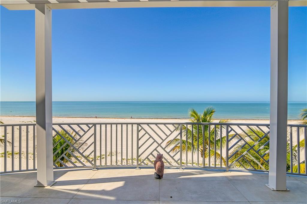 View of patio featuring view of water and beach