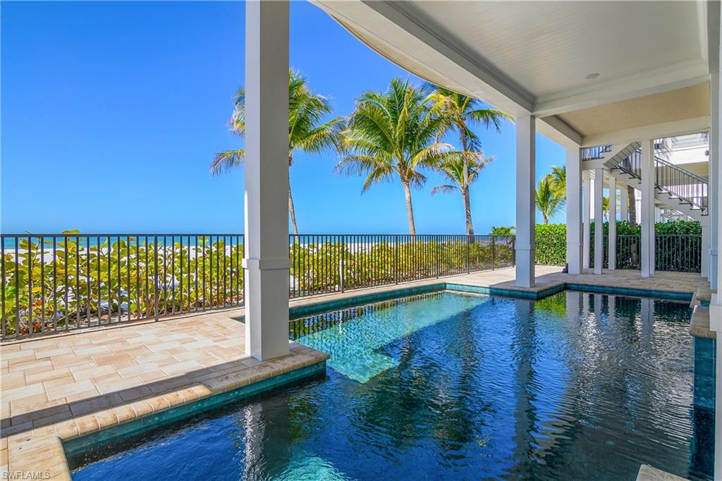 View of pool featuring patio surround and a water view