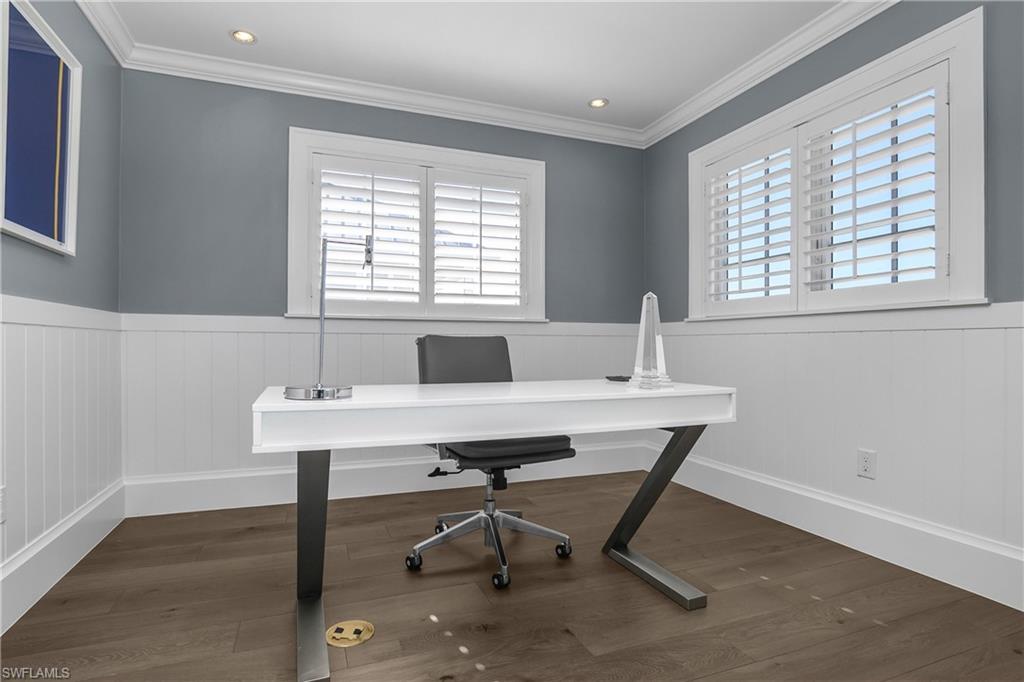 Office area with dark wood-type flooring, a wainscoted wall, recessed lighting, and ornamental molding