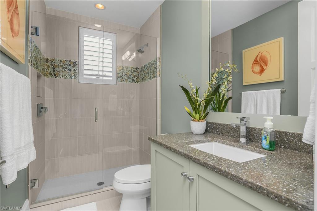 Bathroom with vanity and a stall shower