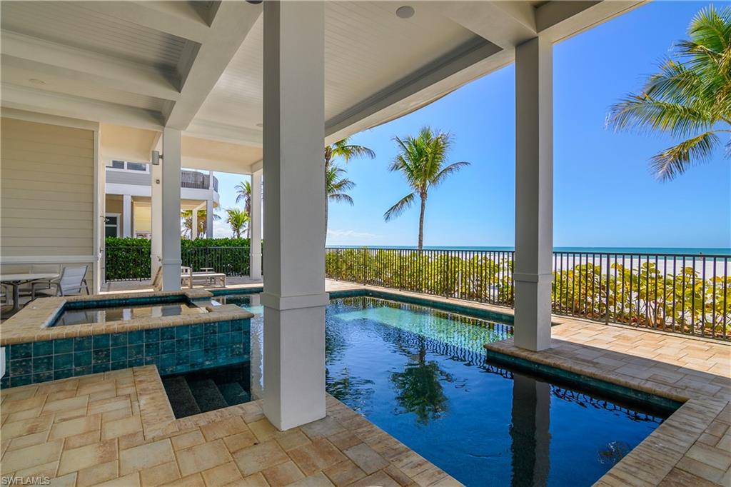 Combined pool / hot tub with a fenced backyard and a patio