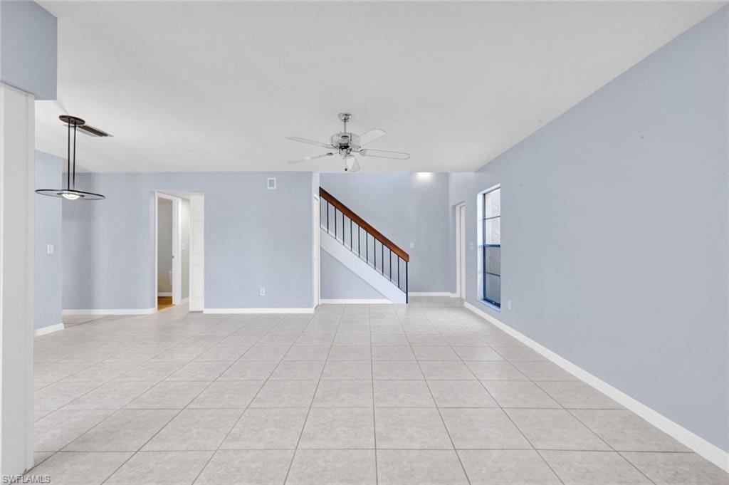 Spare room with ceiling fan and light tile patterned floors