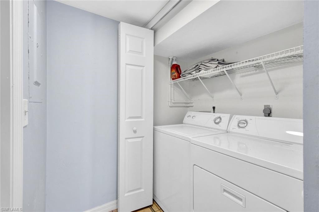 Laundry area with separate washer and dryer and baseboards