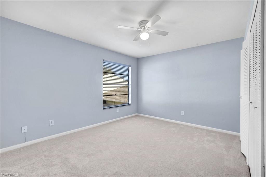Unfurnished bedroom with a closet, light colored carpet, and ceiling fan
