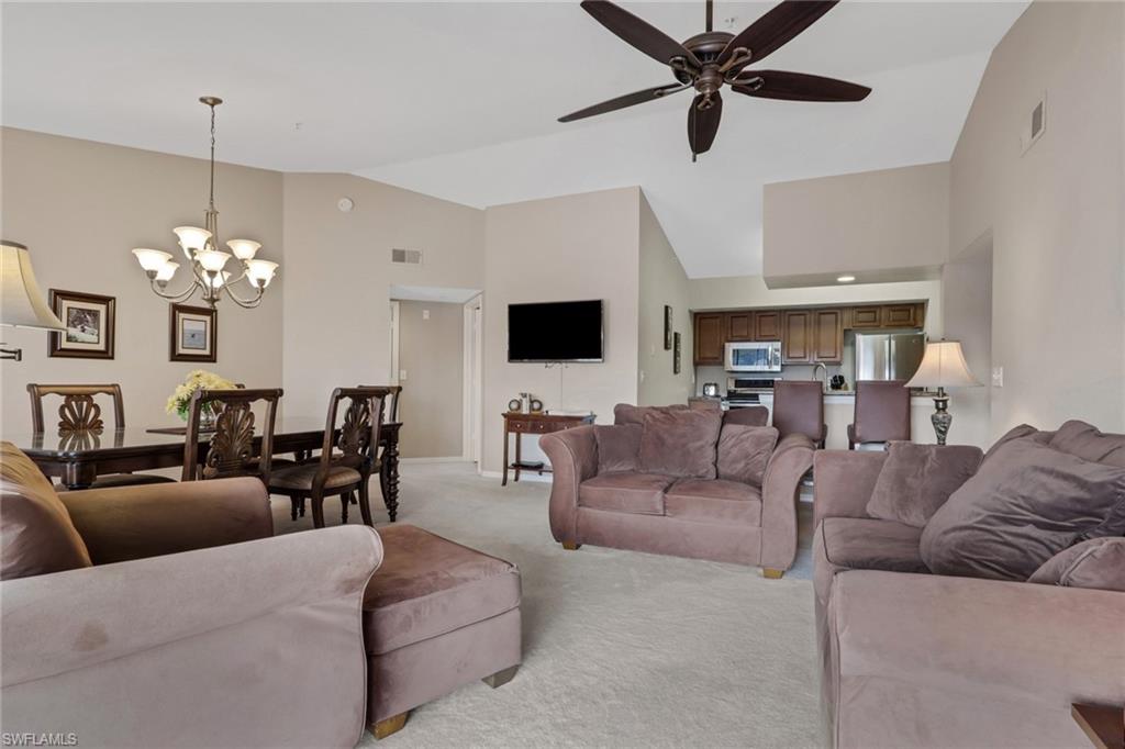 Living room with vaulted ceiling and ceiling fan