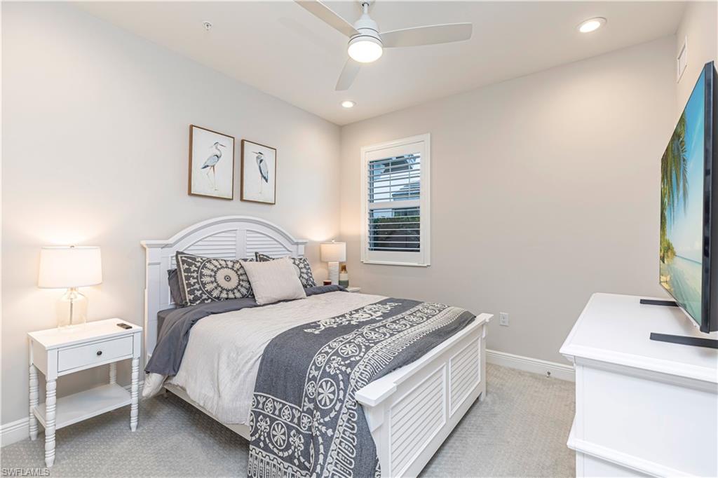 Bedroom featuring ceiling fan, light colored carpet & recessed lighting