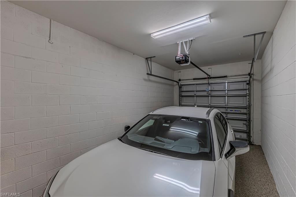 Garage w/ garage door opener & concrete block wall