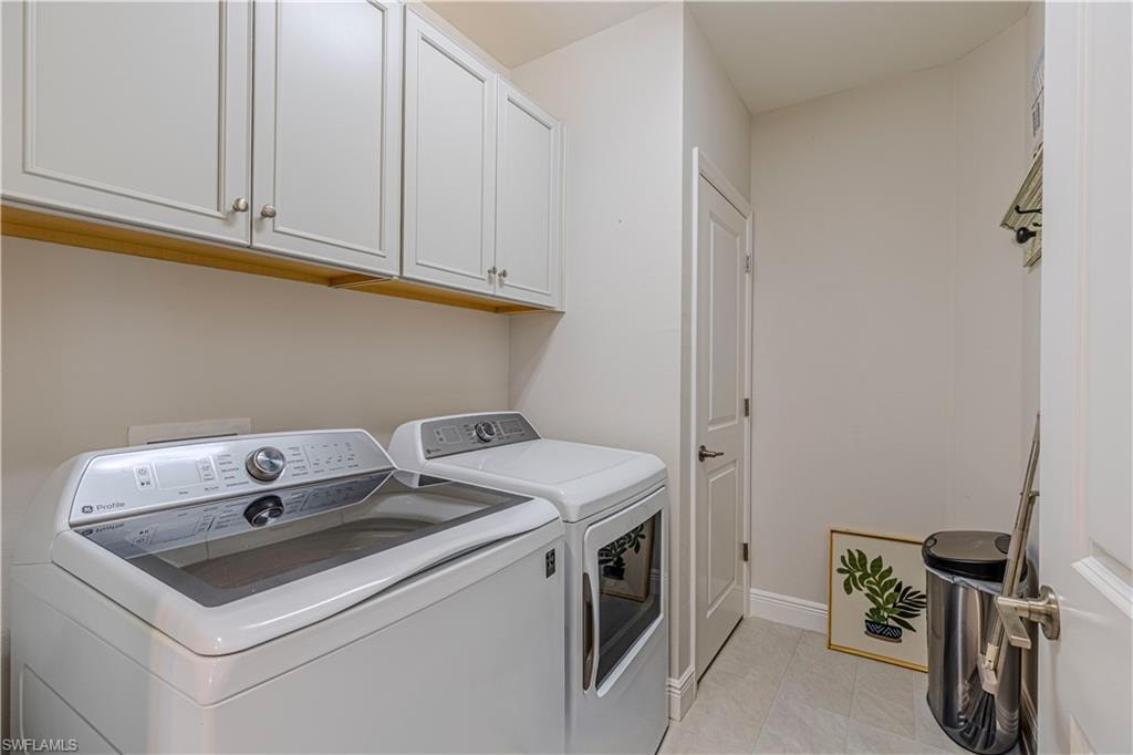 Laundry area w/ cabinet space & washer and dryer