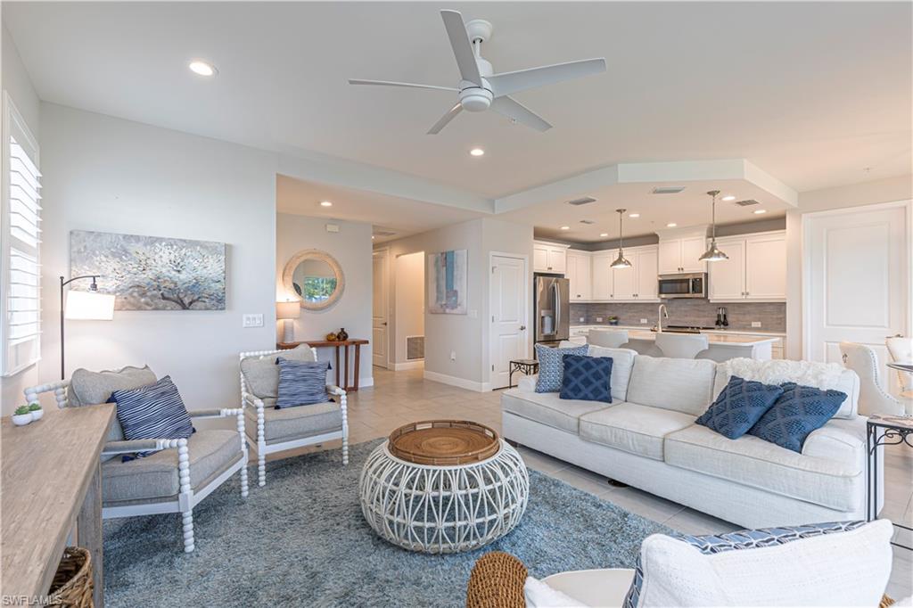 Family room w/ ceiling fan, recessed lighting & light tile patterned floors