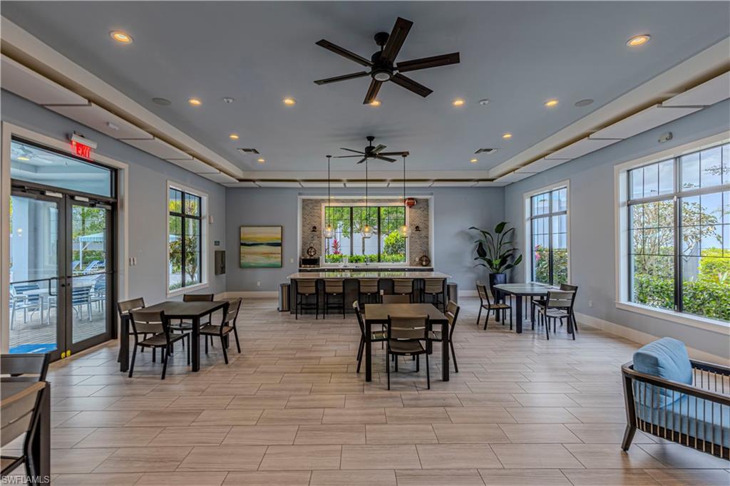 Club house w/ raised ceiling, wood finish floors, healthy amount of natural light, ceiling fans & recessed lighting