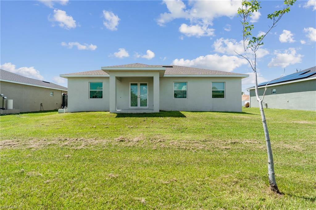 Rear view of house with a lawn