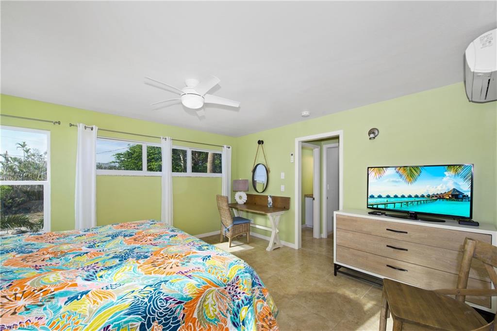 Master Bedroom: Bright bedroom with a tropical-inspired feel - Virtually Edited Image