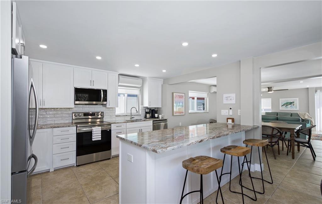 Well-equipped kitchen featuring a breakfast bar - Virtually Edited Image