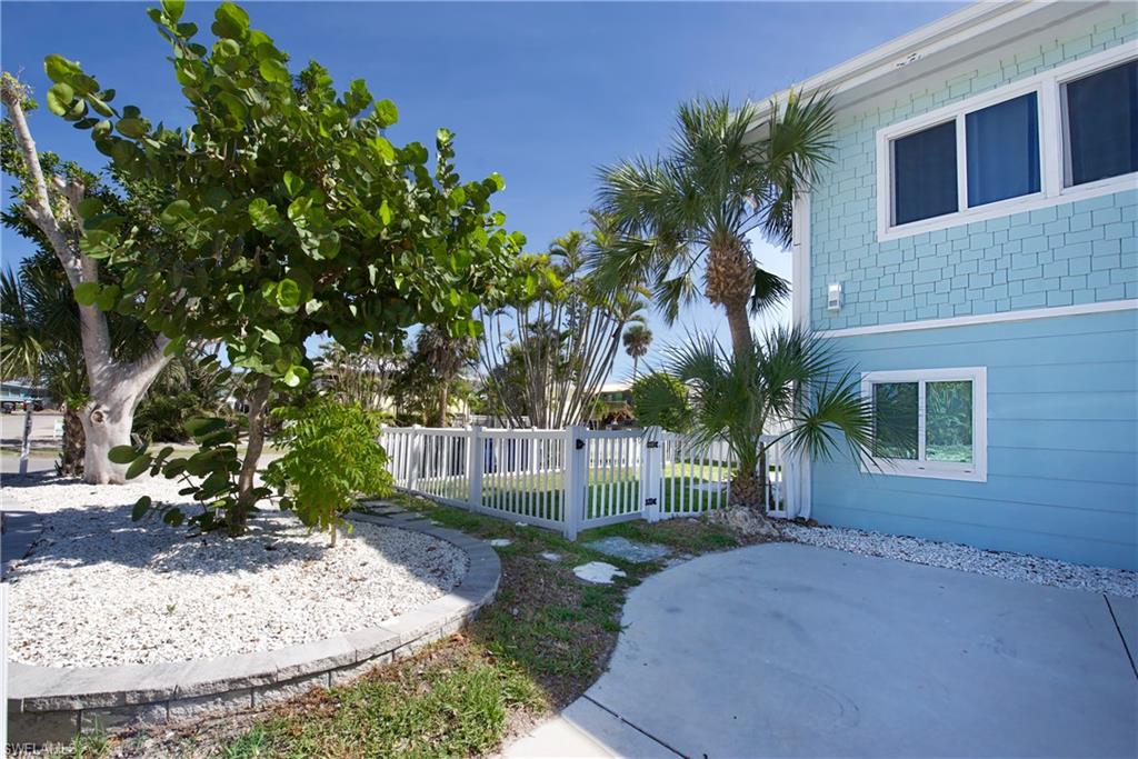 Back Yard: Lush landscaping enhances this coastal property - Virtually Edited Image