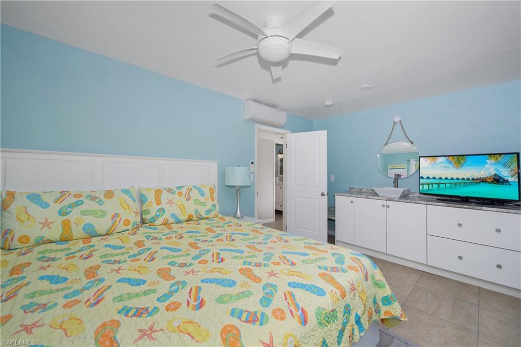 Relaxing bedroom featuring a queen bed and ample storage - Virtually Edited Image