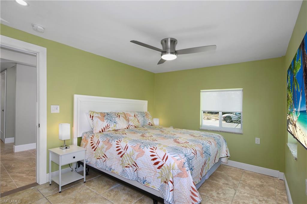 Master Bedroom: Bright bedroom with a tropical-inspired feel - Virtually Edited Image