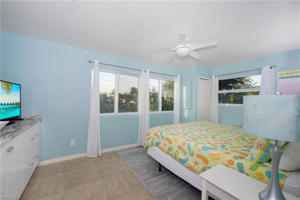 Inviting bedroom with a ceiling fan and modern amenities - Virtually Edited Image