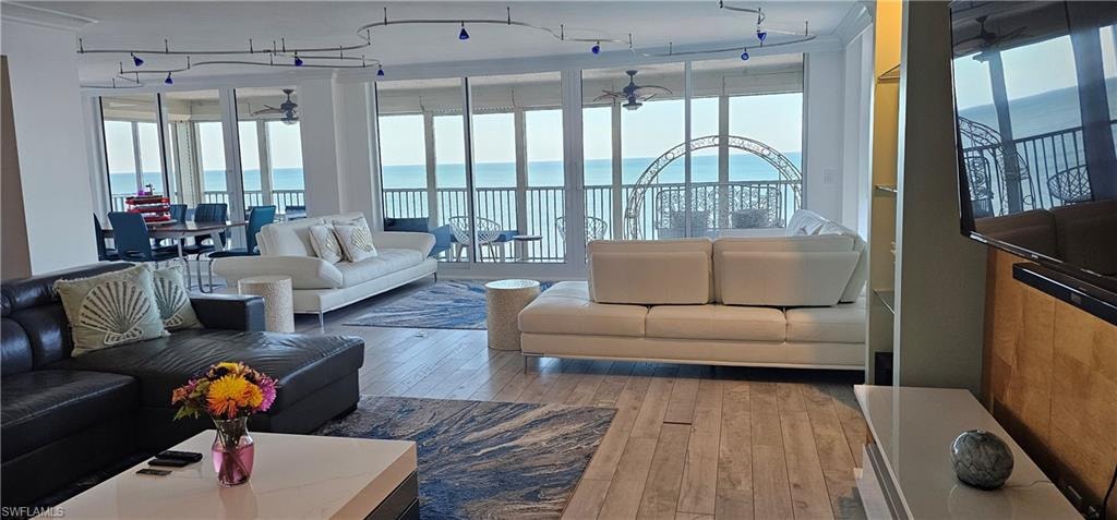 Living area featuring light wood-style flooring and ceiling fan
