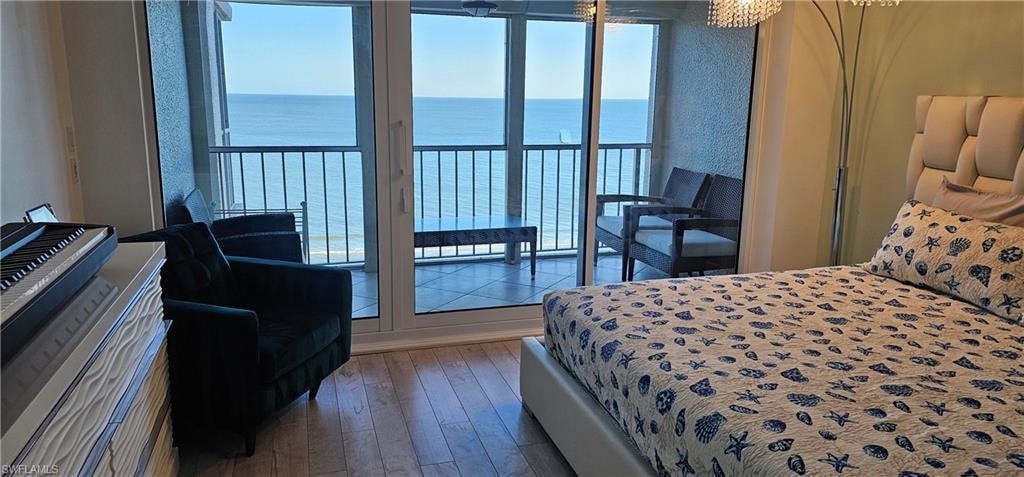 Bedroom featuring light wood finished floors and a water view