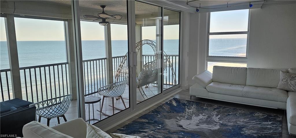Sunroom / solarium with a water view and healthy amount of natural light