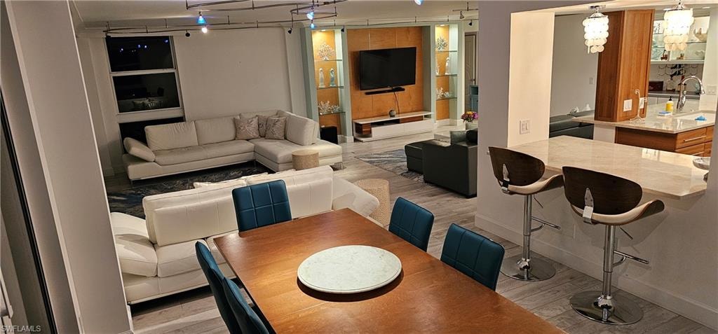 Dining room featuring light wood-style flooring and rail lighting