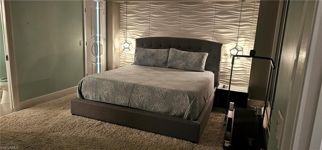 Carpeted bedroom featuring baseboards