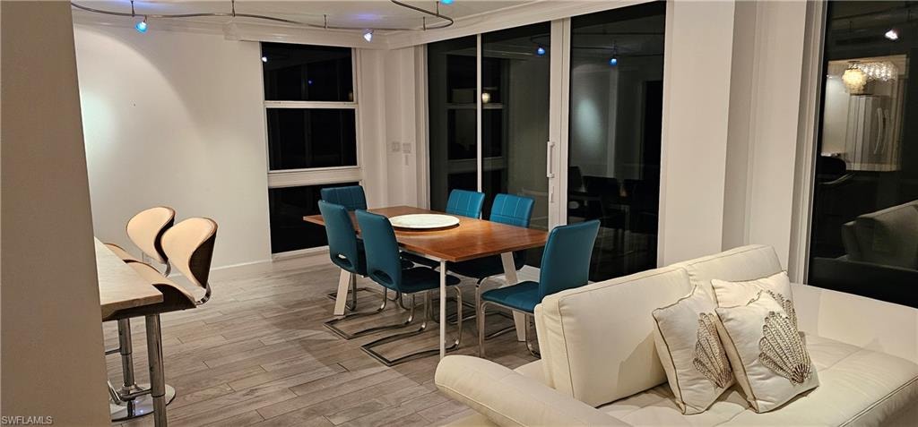 Dining space featuring light wood finished floors and track lighting