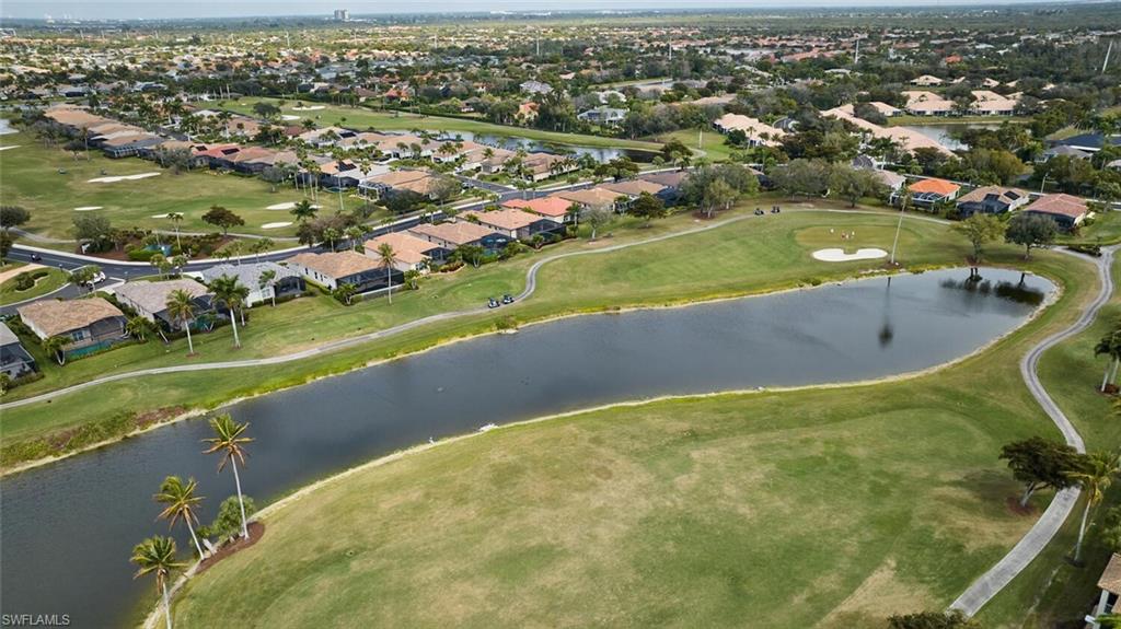 Aerial overview of property's location featuring a local golf course, nearby suburban area, and a nearby body of water